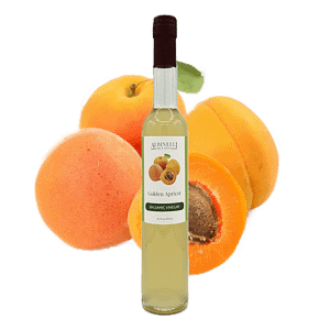 a bottle of balsamic in front of a grouping of apricots