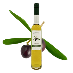 bottle of olive oil in front of a arbequina olive