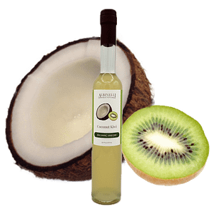 Half a coconut and kiwi behind a bottle of balsamic