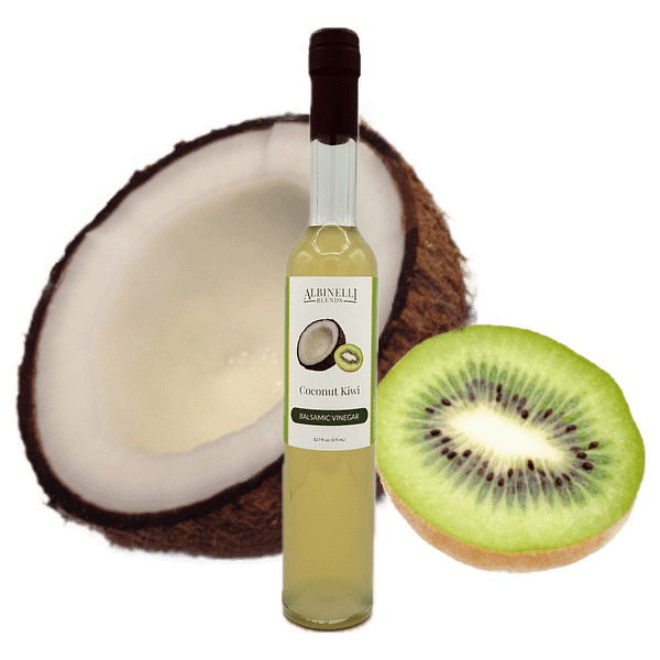 Half a coconut and kiwi behind a bottle of balsamic
