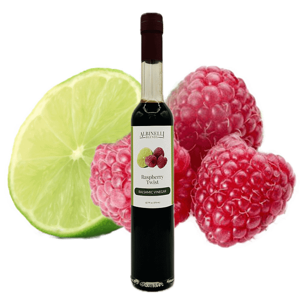bottle of balsamic in front of a sliced lime and raspberry cluster