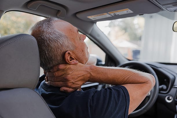 Middle-aged man with neck pain | Walker Road Chiropractic Whiplash Treatment