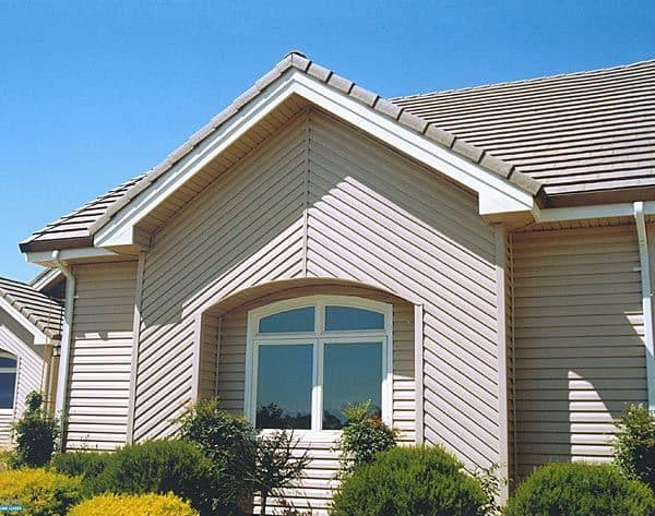 Exterior photo of light brown siding that was installed as part of a K-Designers exterior remodel.
